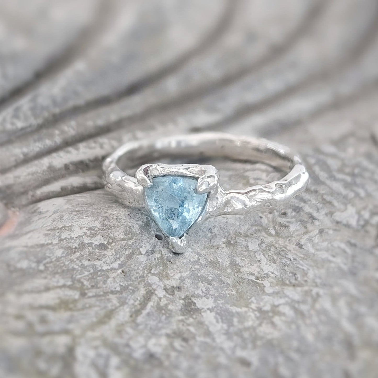 Solid Silver Aquamarine ring with a trilliant shape gemstone on an organic textured band.
