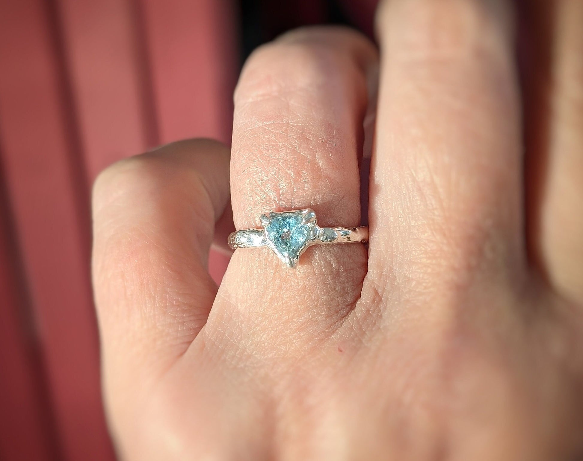 Solid silver ring featuring a trilliant shape aquamarine gemstone, showcasing unique handcrafted design.