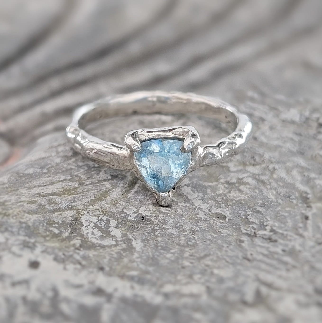 Handcrafted solid silver ring featuring a trilliant aquamarine gemstone, symbolizing love and individuality.