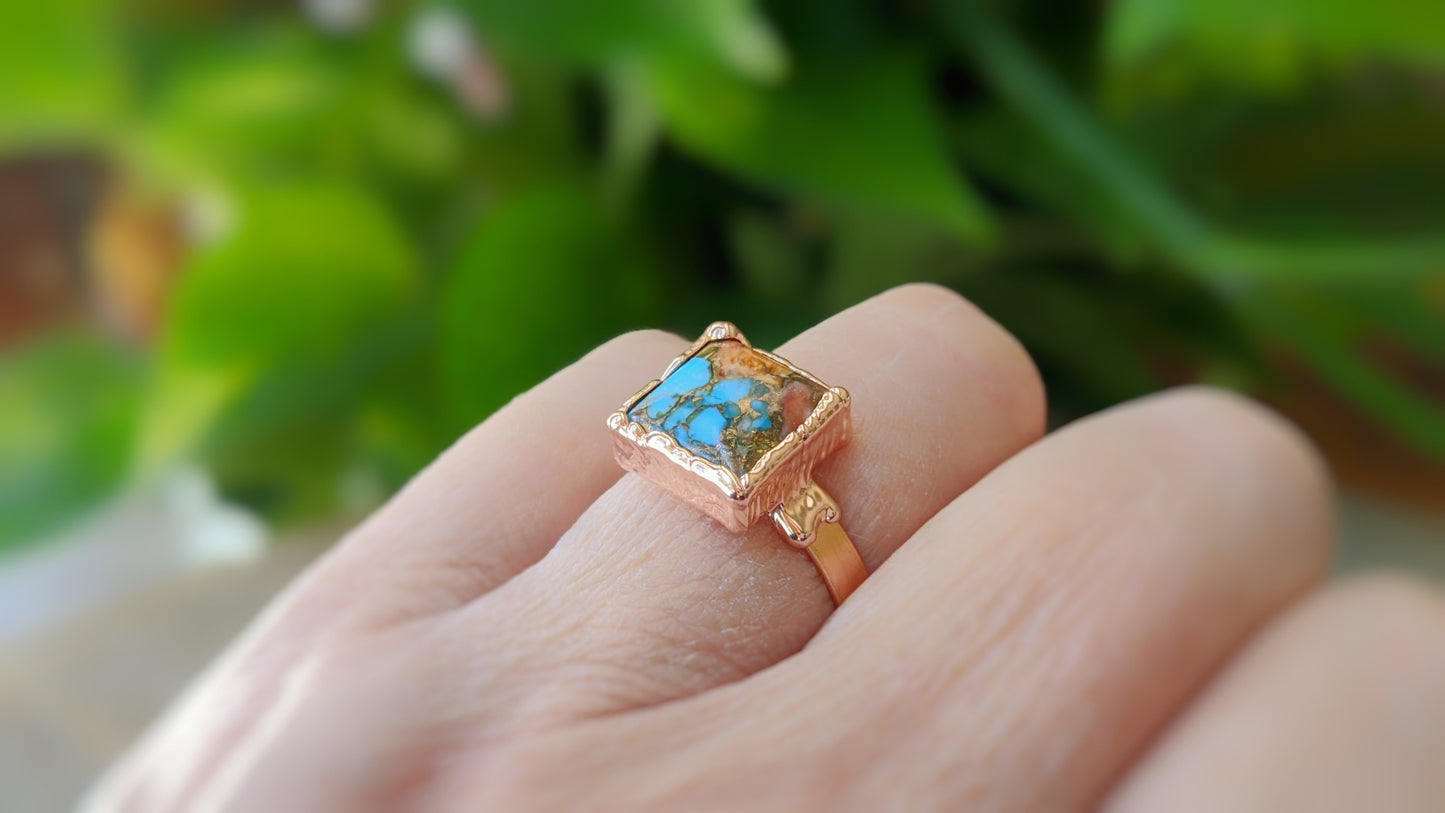 Handcrafted Spiny Oyster Copper Turquoise ring on a hand, featuring a square stone set on a 14k gold filled band.