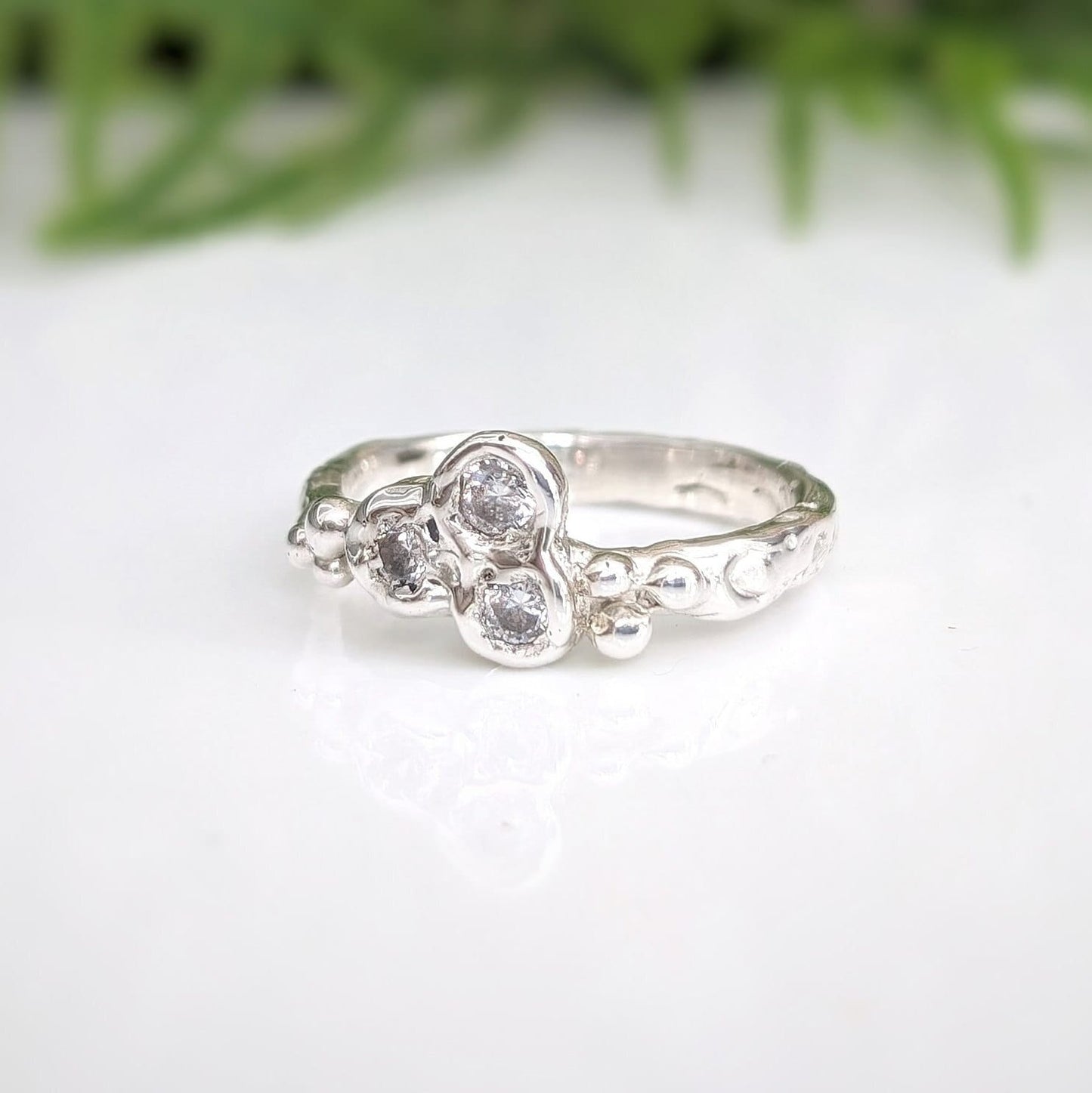 Handcrafted silver CZ cluster ring featuring organic design and sparkling cubic zirconia stones.