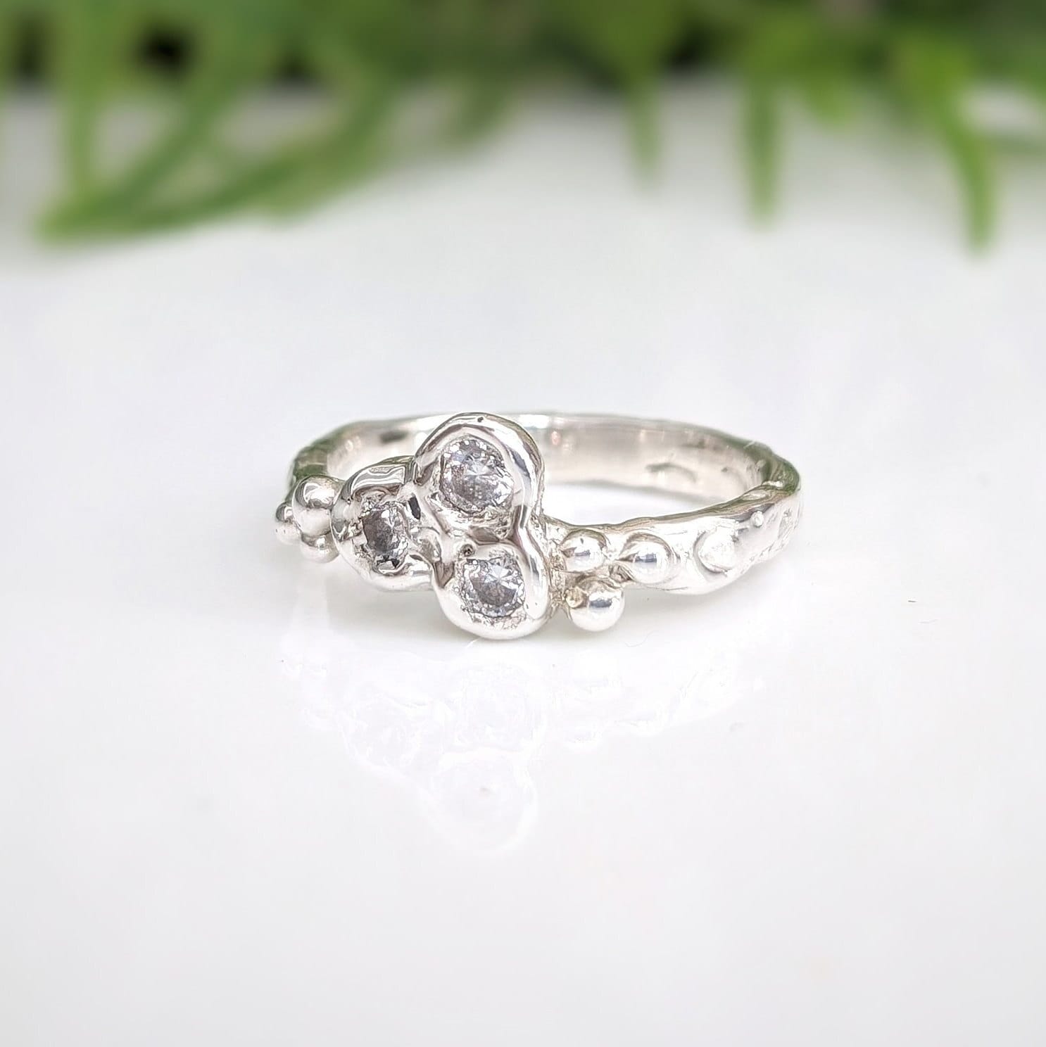 Handcrafted silver CZ cluster ring featuring organic design and sparkling cubic zirconia stones.