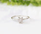 Delicate sterling silver raw diamond engagement ring with a unique prong setting and sparkling conflict-free diamond.