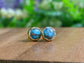 Turquoise stud earrings with 10mm round stones set in gold, showcasing classic and timeless design.