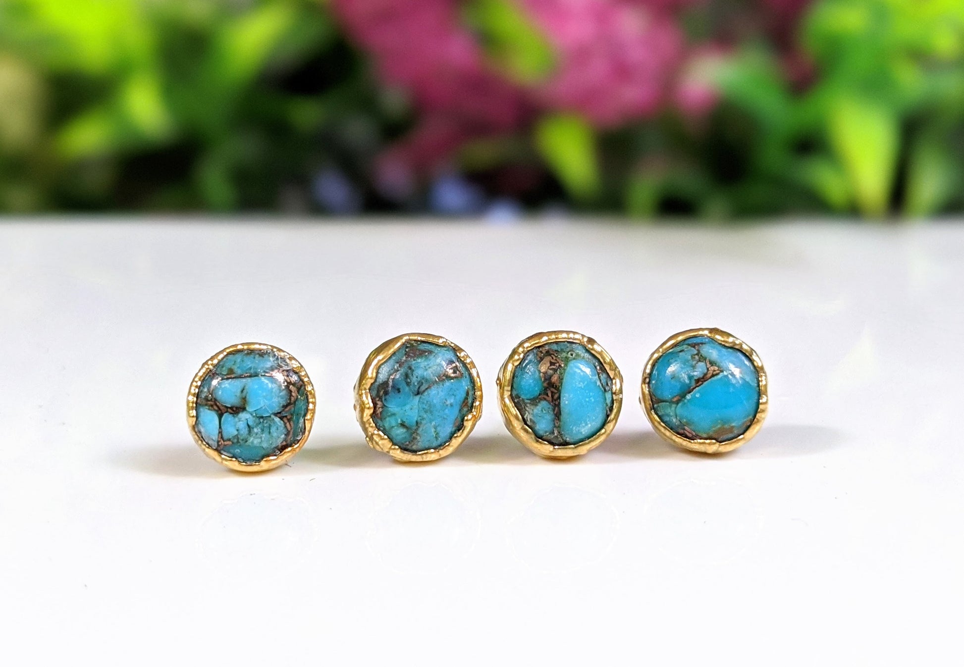Turquoise stud earrings featuring 10mm round copper turquoise stones set on gold filled posts.