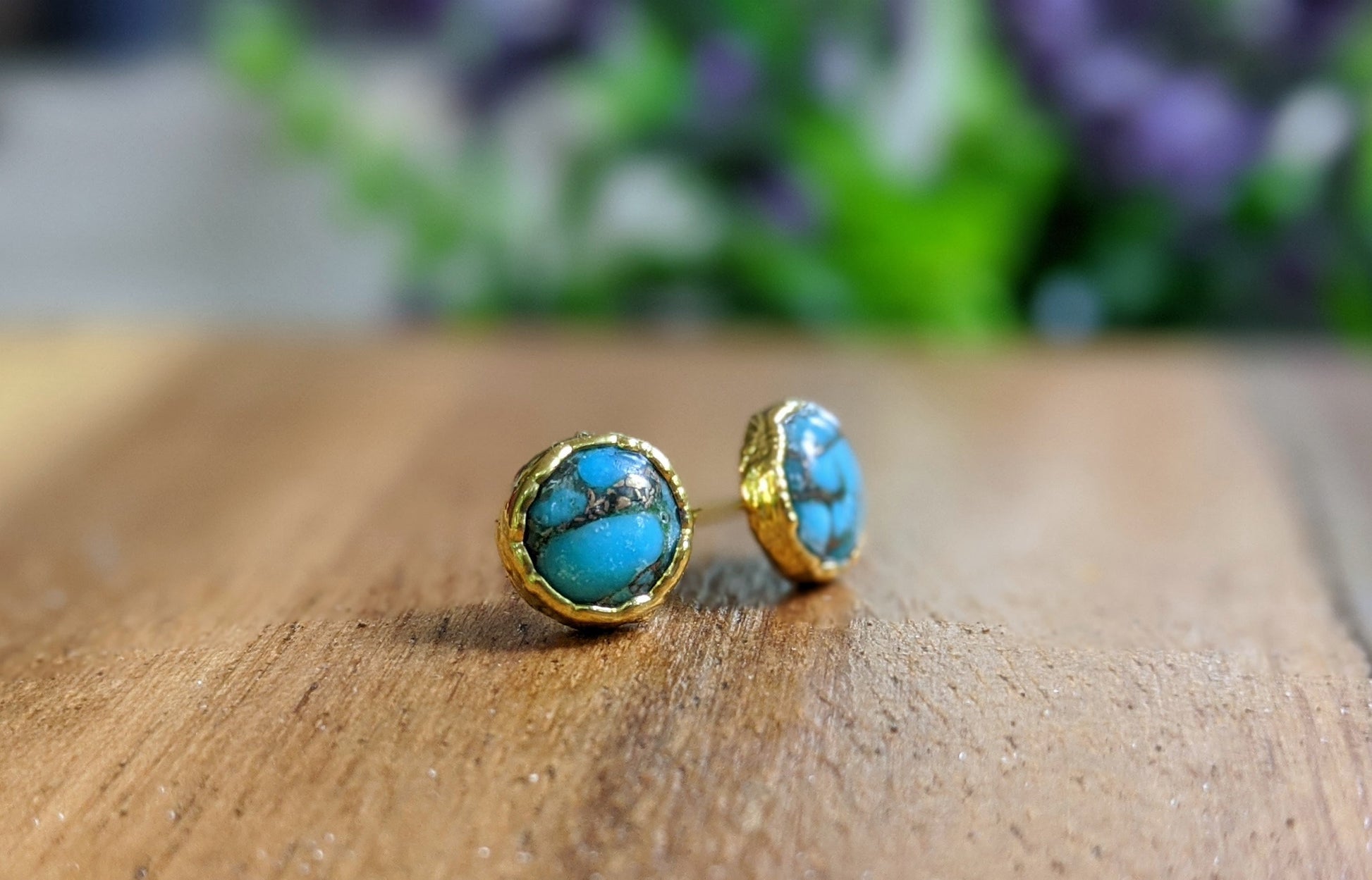Classic turquoise stud earrings with 10mm round copper stones set in 14k gold filled posts on a wooden surface.