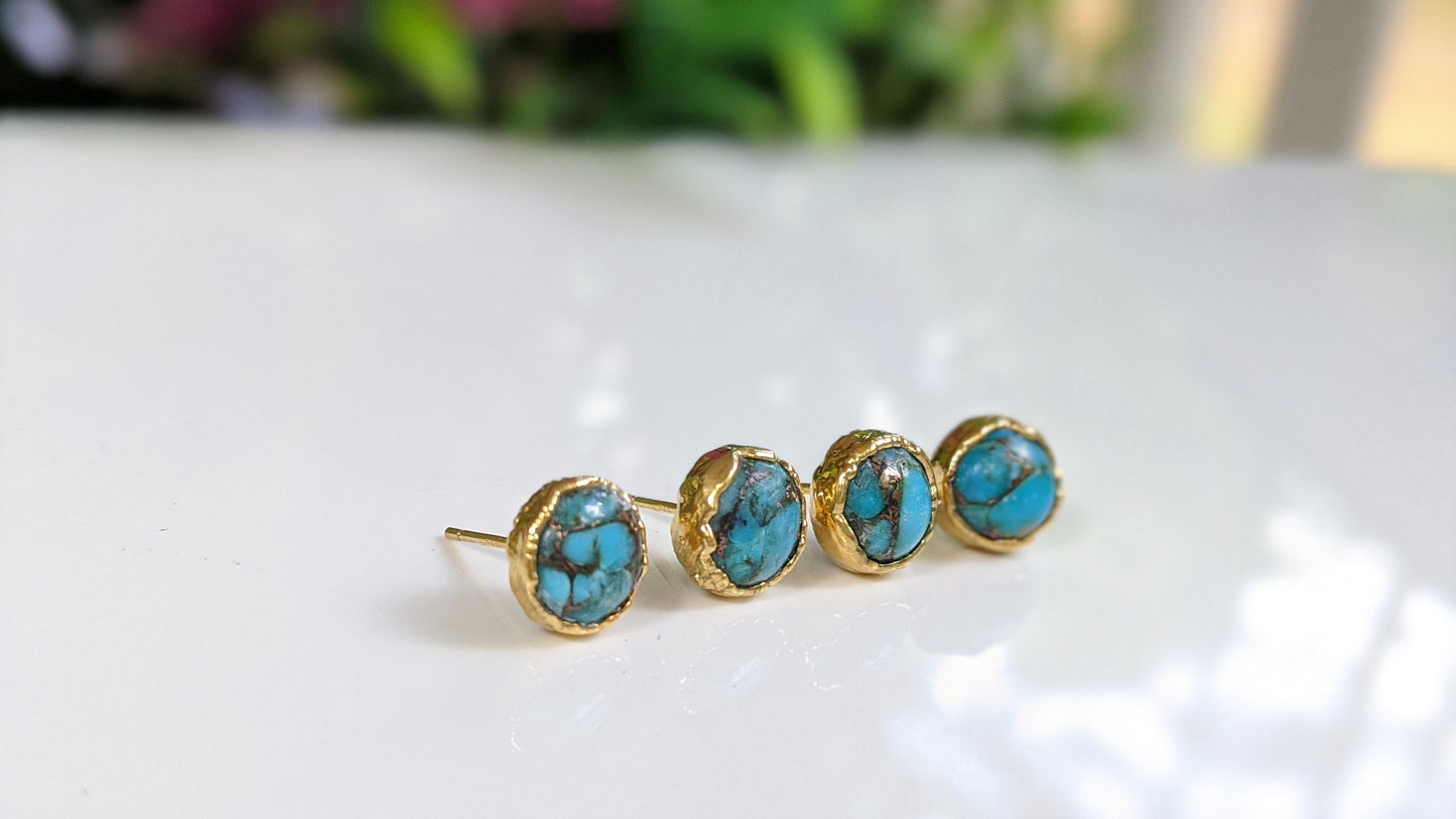 Stylish turquoise stud earrings featuring round copper stones set in gold-filled posts.
