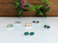 Handcrafted Australian Opal stud earrings on display, showcasing unique colors and 18k Gold accents.