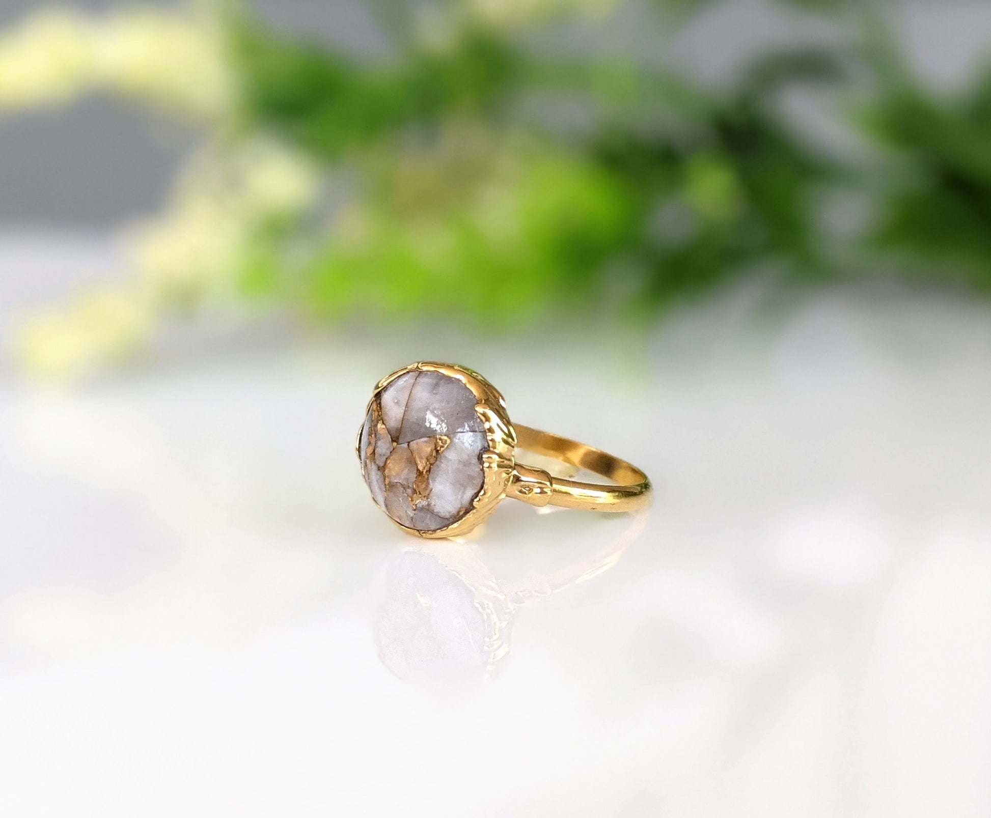 Elegant white crystal copper ring on a 14k gold filled band, plated in 18k gold, showcasing natural gemstone details.